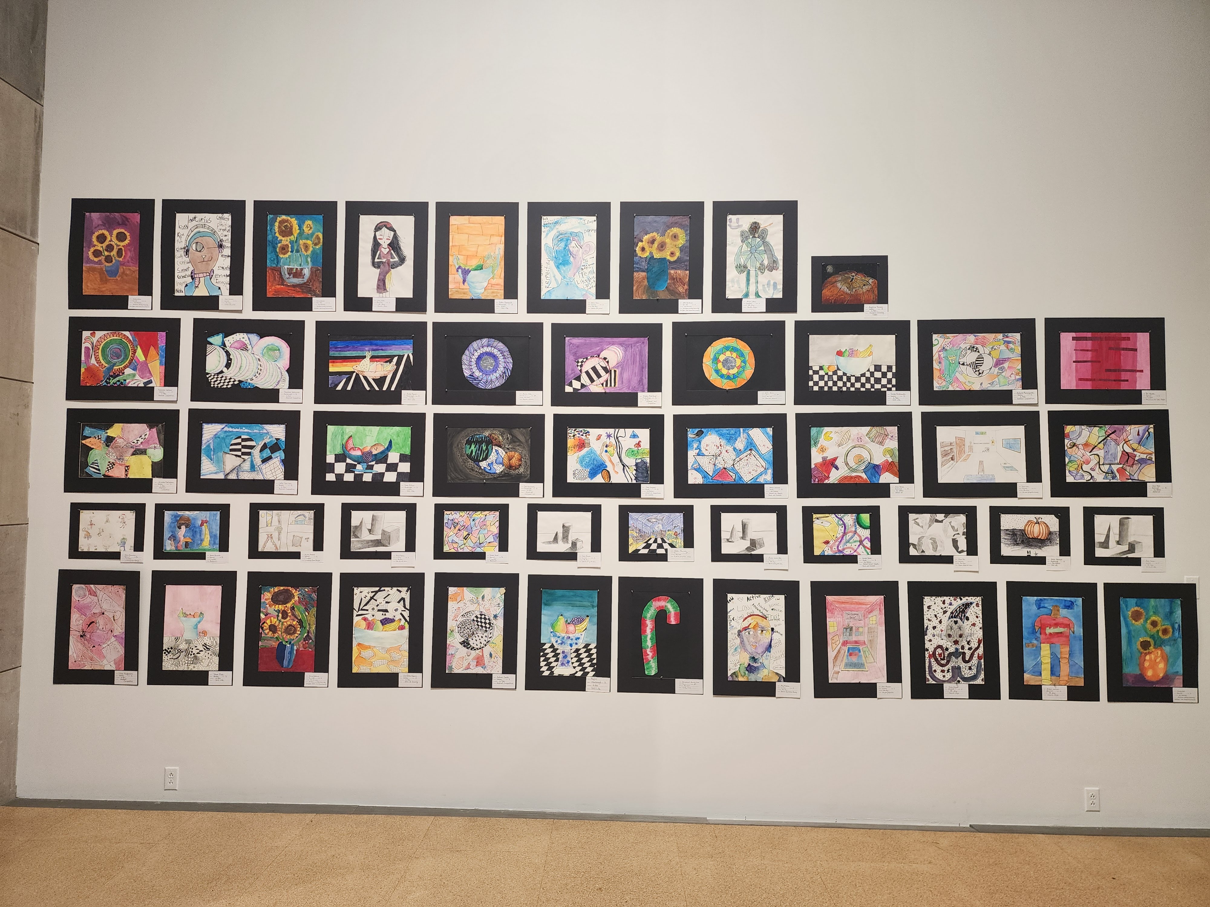 Various pieces of student artwork on display at the gallery